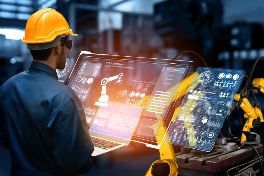 worker controlling the robot through a computer